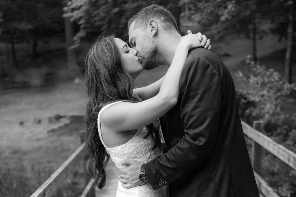 Black and white image of newly engagement couple kissing