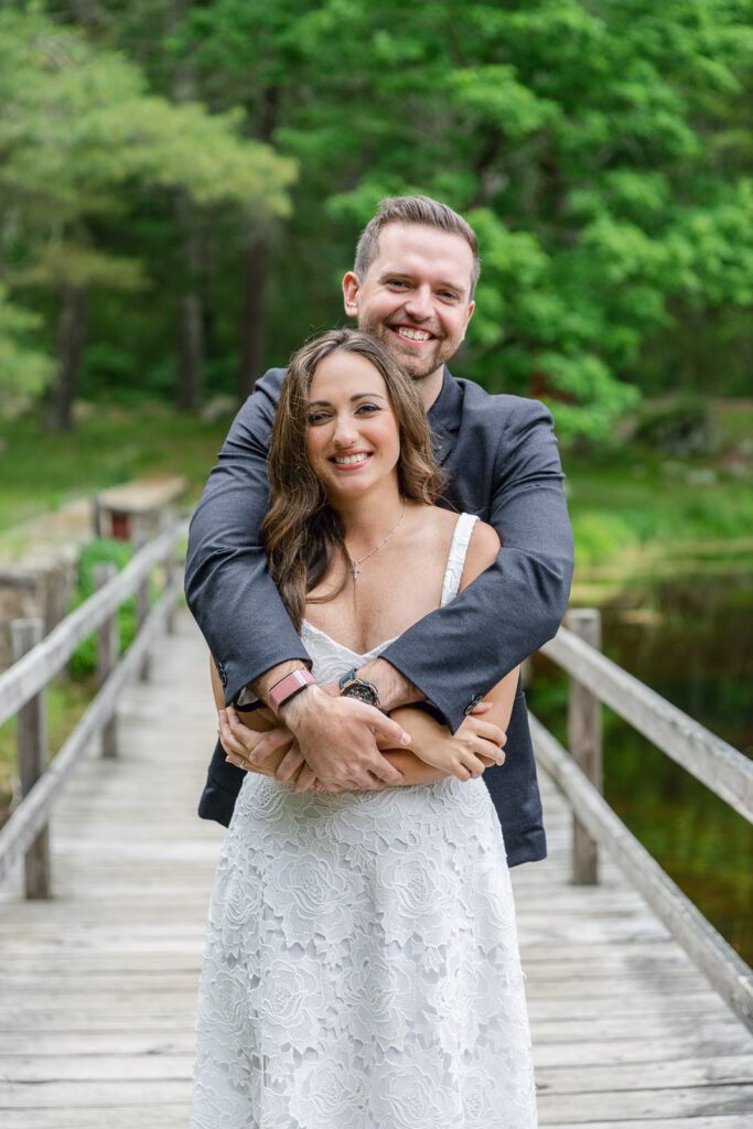 Newly engagement couple posing on a bridge during their engagement photo shoot in RI