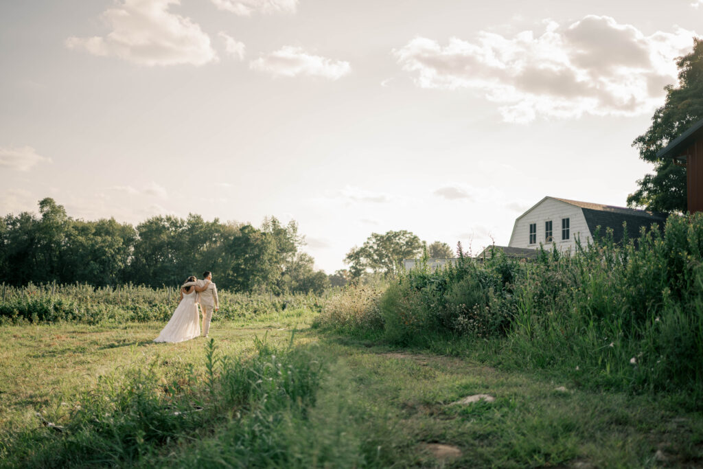Natural wedding photography capturing a private moment between bride and groom in orchard