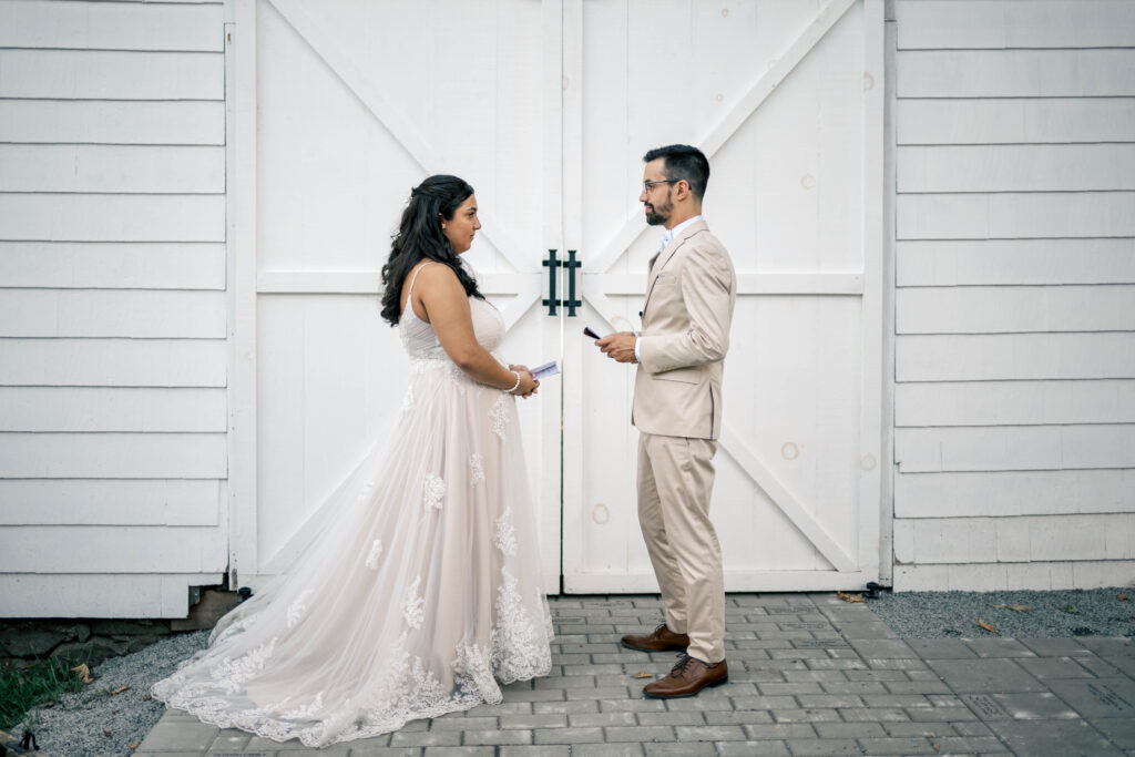 Bride and groom having quiet, heartfelt vow exchange during intimate orchard wedding