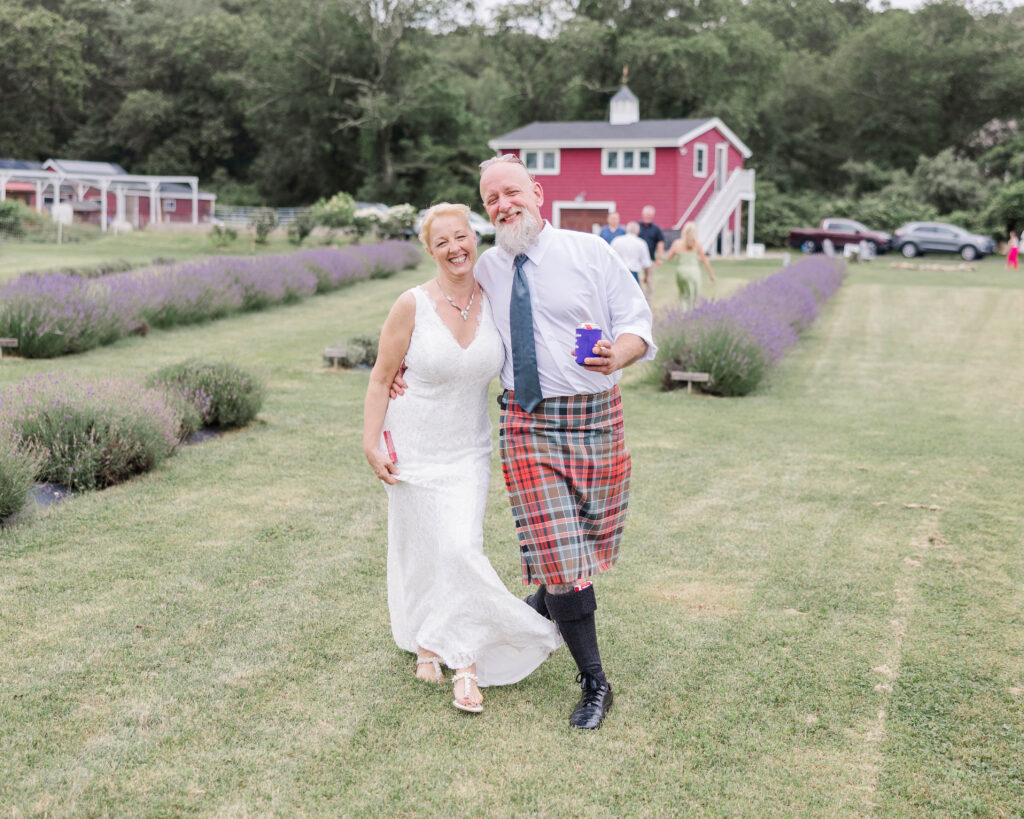 Bride and groom smiling and laughing enjoying a drink after their intimate wedding ceremony in Rhode Island