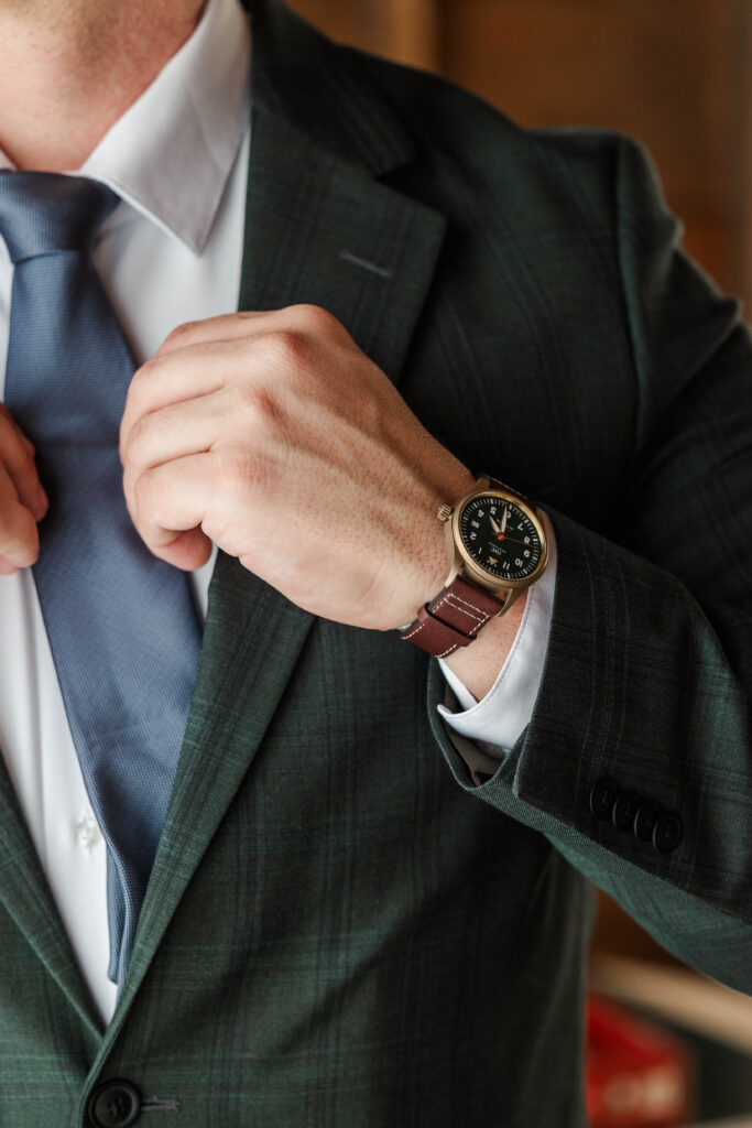 Getting ready photo of groom, highlighting the details of his watch before his intimate wedding ceremony in Rhode Island