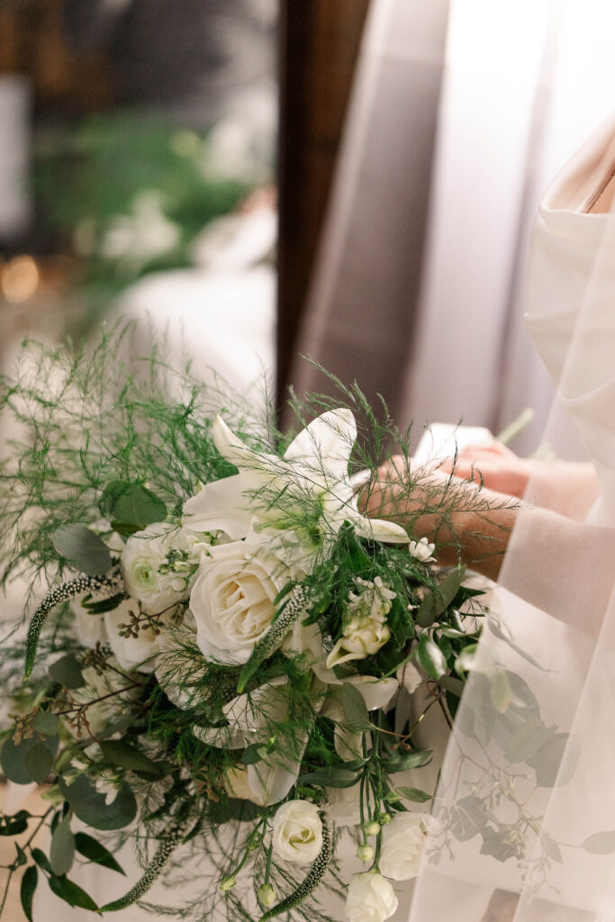 Bridal bouquet resting on the bride's lap moments before she walks down the aisle during her intimate wedding ceremony at Barden Family Orchard in Rhode Island.